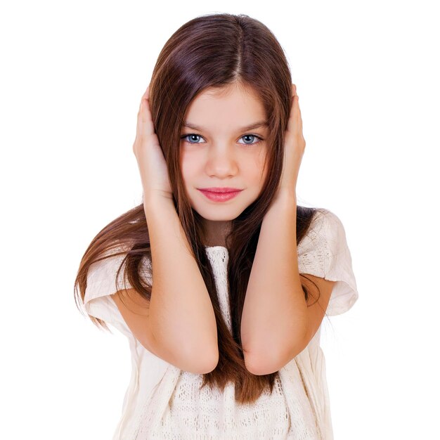 Photo portrait of a charming little girl covering ears with hands isolated on white background