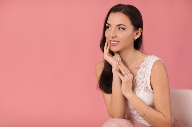 Portrait of charming woman on pink background