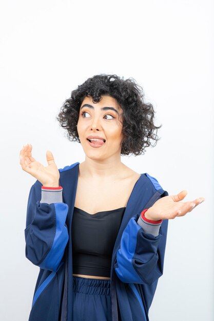 Portrait of a charming woman with curly hair looking away.