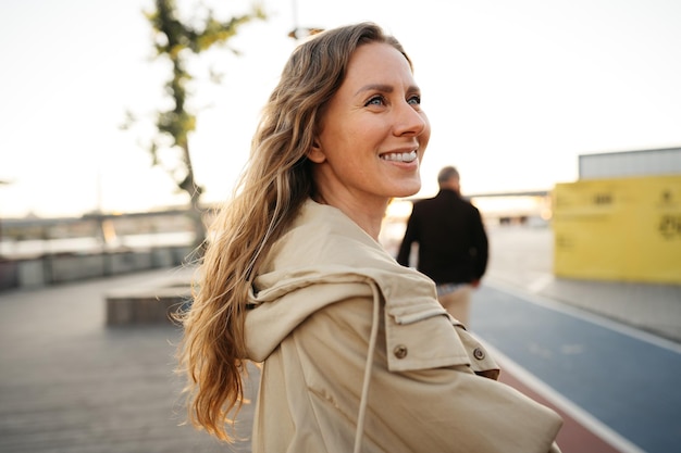 Portrait of a charming young woman posing for camera in the city