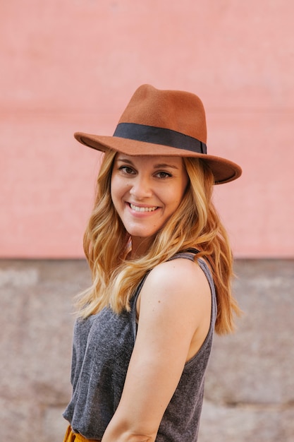 Portrait of a cheerful blonde woman with hat