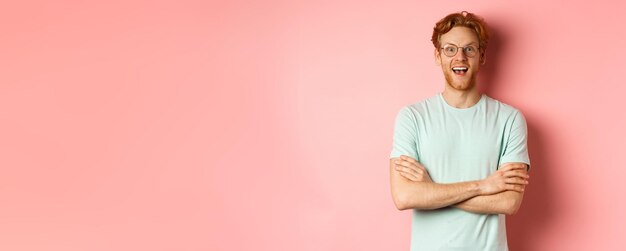 Portrait of cheerful european man in glasses looking amazed at camera see interesting promotion stan