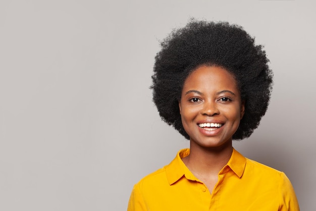 Portrait of cheerful excited woman smiling on white studio wall background