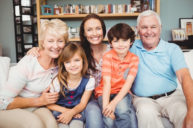 Portrait of cheerful family sitting on sofa