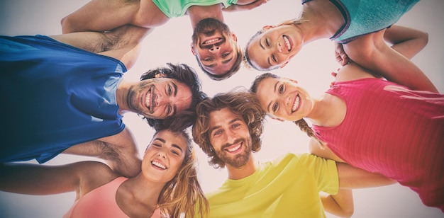 Portrait of cheerful friends huddling