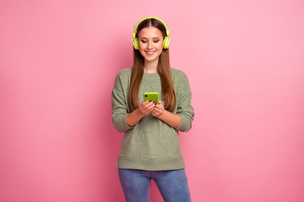 Portrait of cheerful girl use cellphone have headphones listen music