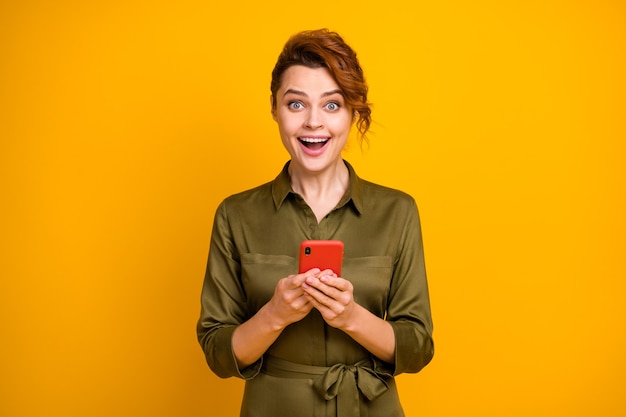 Portrait of cheerful glad amazed girl using telephone crazy face