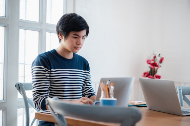 Portrait of cheerful handsome guy working at home.