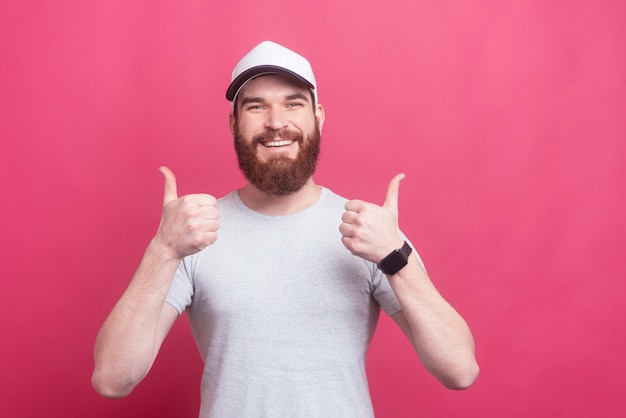 Portrait of cheerful handsome man showing thumbs up