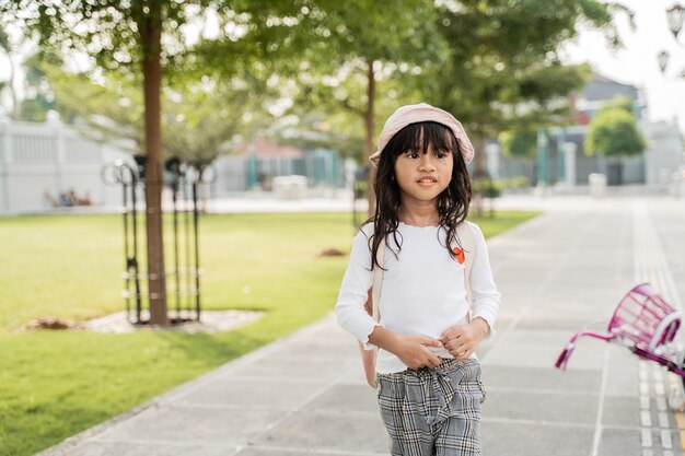 A portrait of a cheerful little girl in the park