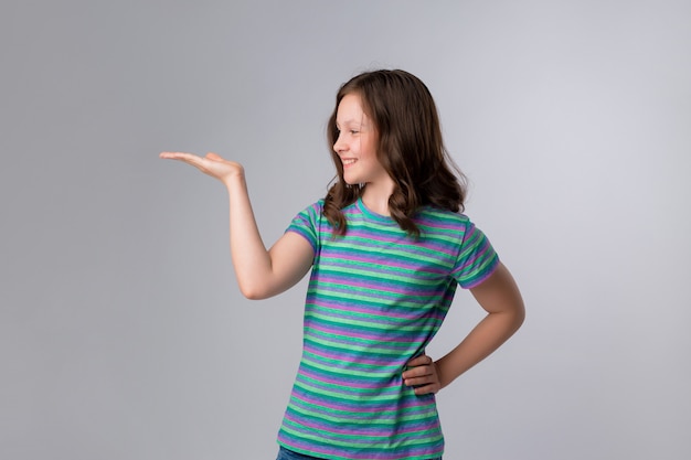 Portrait of cheerful little girl showing thumbs up