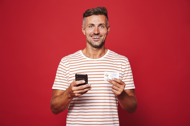 Portrait of a cheerful man standing on red