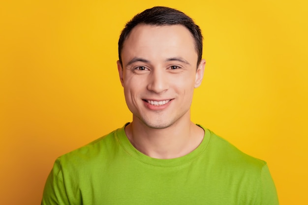 Portrait of cheerful positive man look camera shiny smile on yellow background