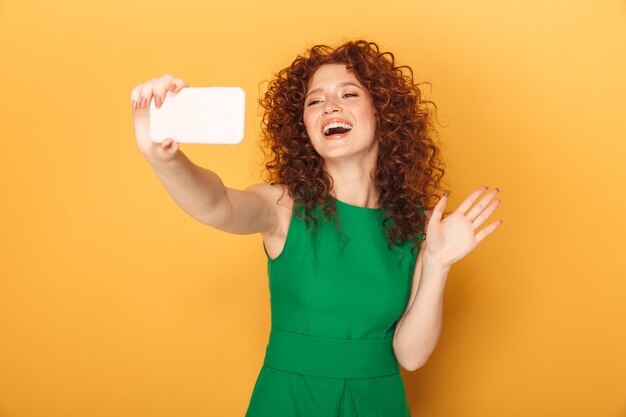 Portrait of a cheerful redhead woman in dress