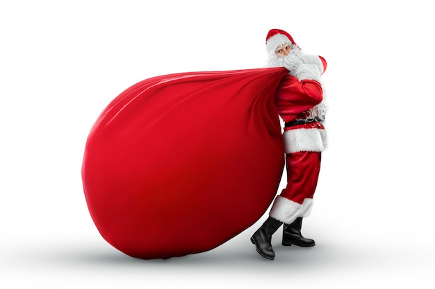 Portrait of a cheerful Santa Claus in a red suit carring a big bag