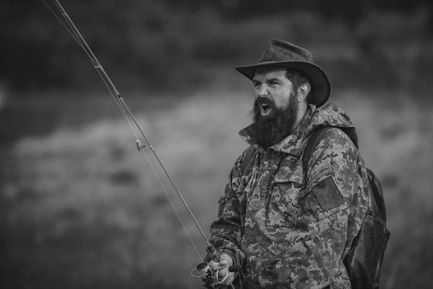 Portrait of cheerful senior man fishing Guy fly fishing Catching and fishing Male hobby Rural getaway Mature man fly fishing Weekend Man catching fish Active day Trout bait