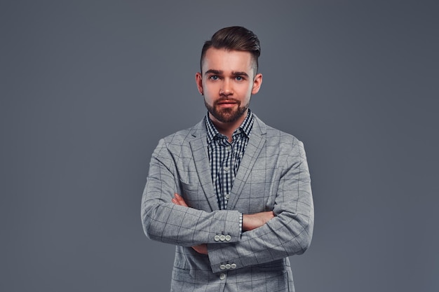 Portrait of cheerful smiling man in checkered blazer and shirt. He is crossing his hands.