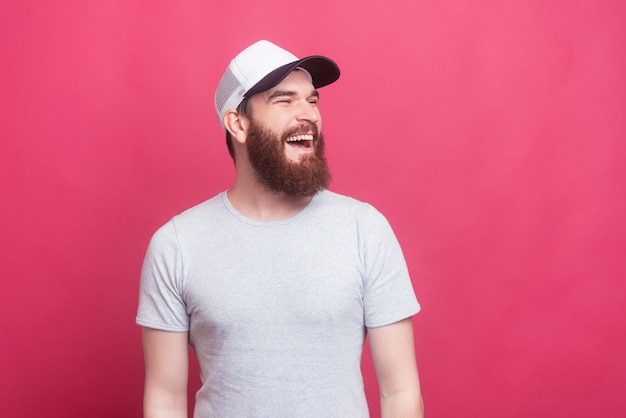 Portrait of cheerful smiling trendy man looking aside