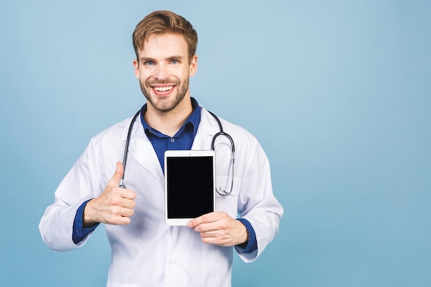 Portrait of cheerful smiling young doctor with stethoscope isolated