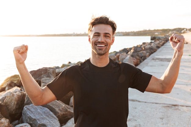 Portrait of a cheerful sportsman celebrating success