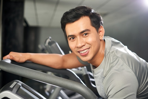 Portrait of cheerful sporty man in gym