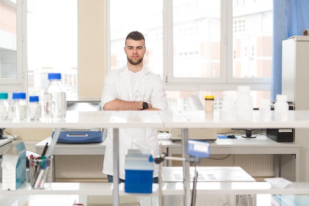 Portrait Of Cheerful Student Man Standing In Class