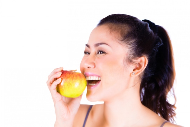 Portrait of cheerful woman eating apple