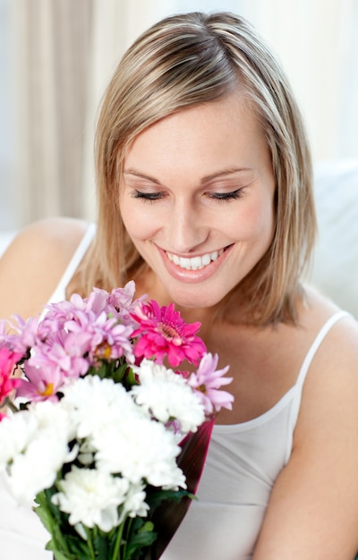 portrait of a cheerful woman holding a bunch of flowers 