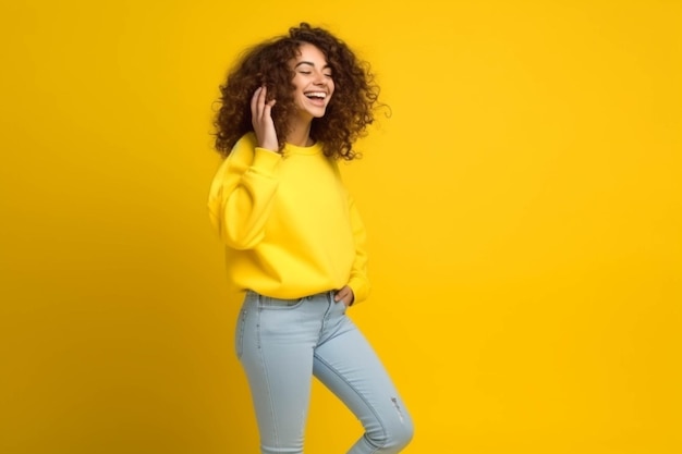 Portrait of cheerful woman in yellow sweater and blue jeans running isolated over yellow background