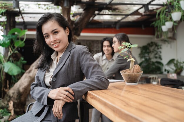 Portrait cheerful of young asian business team meeting in a cafe