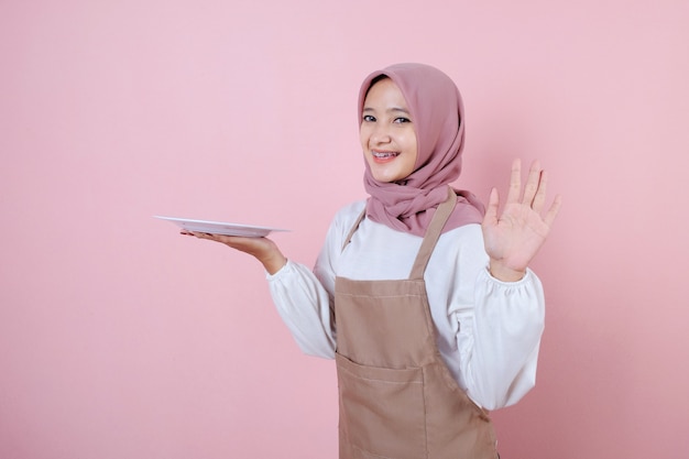 Portrait cheerful young asian woman with white dish or plate