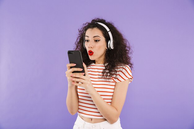 Portrait of a cheerful young casual woman listening to music