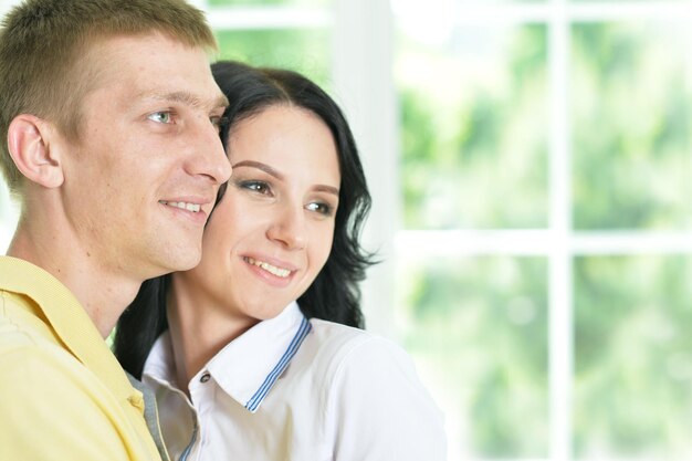 Portrait of a cheerful young couple hugging