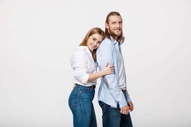 Portrait of cheerful young couple standing and hugging each other 