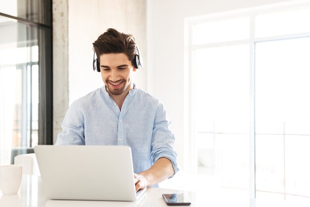 Portrait of a cheerful young man in earphones