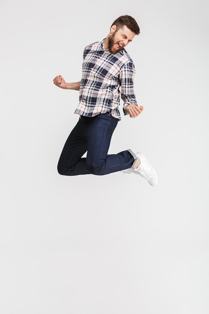 Portrait of a cheerful young man in plaid shirt