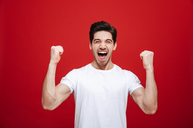 Portrait of a cheerful young man in white t-shirt