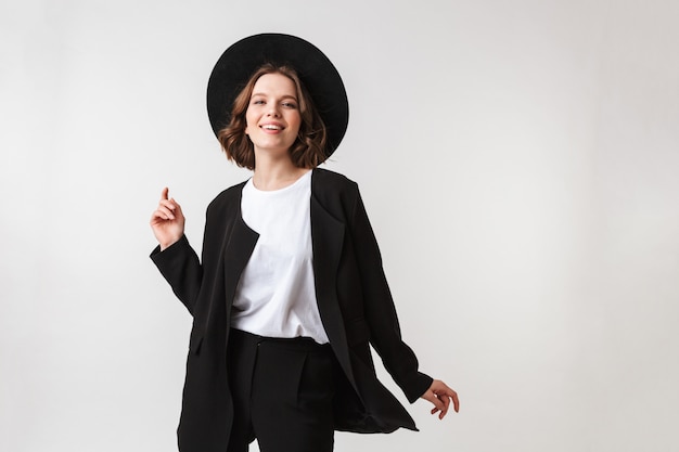 Portrait of a cheerful young woman dressed in black jacket