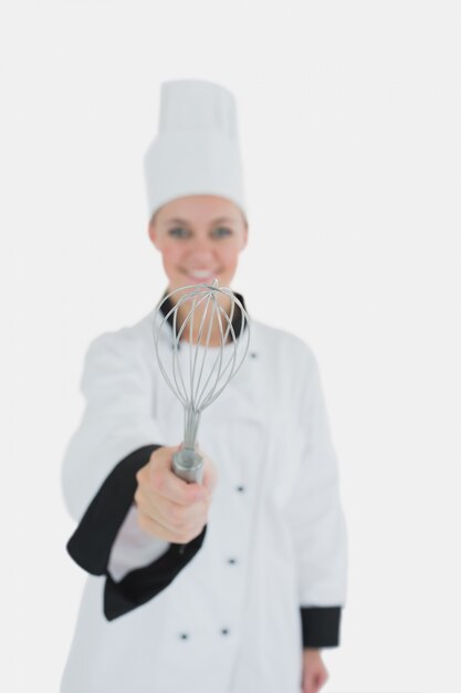 Photo portrait of chef holding wire whisk