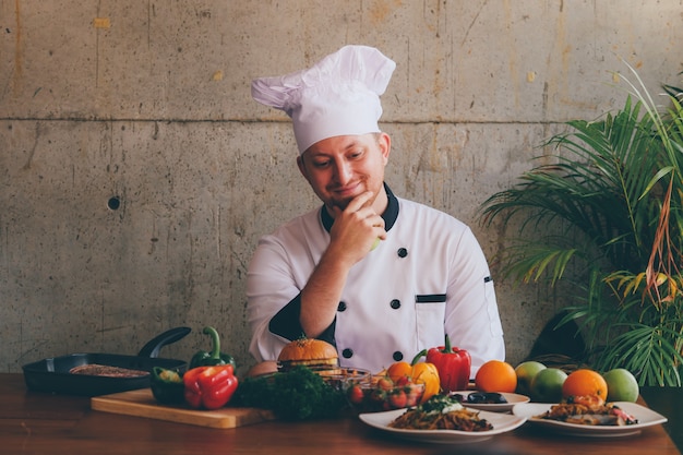 Portrait Chef man  in kitchen with food and vegetables