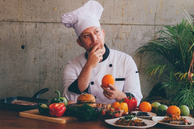 Portrait Chef man  in kitchen with food and vegetables