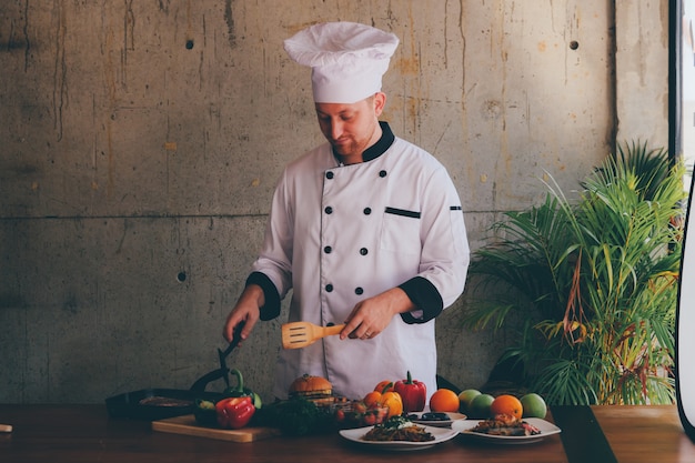 Portrait Chef man  in kitchen with food and vegetables