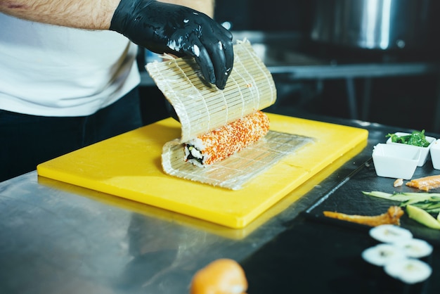 Portrait of Chef preparing rolls in kitchen, fresh and tasty japan food