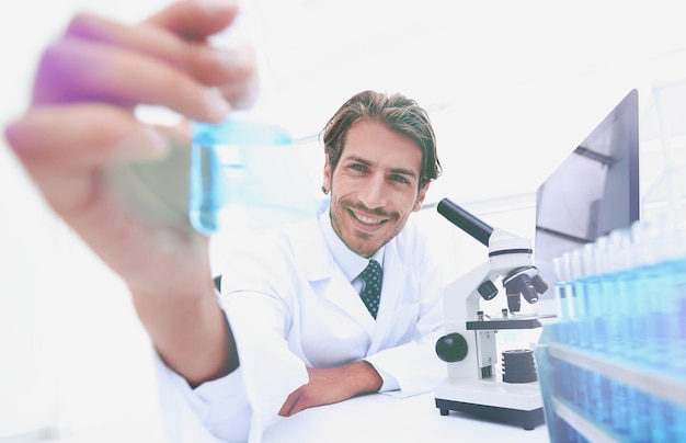 Portrait of a chemist holding a tube with liquid