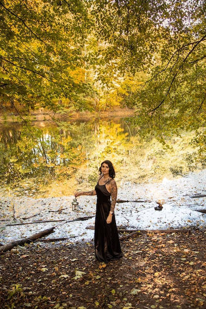 Portrait of chic darkhaired tattooed young woman