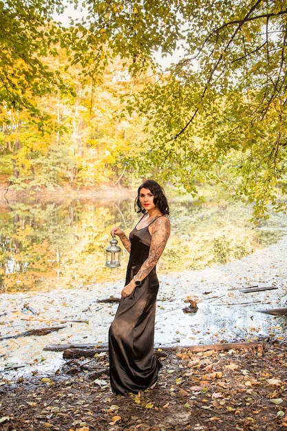 Portrait of chic darkhaired tattooed young woman