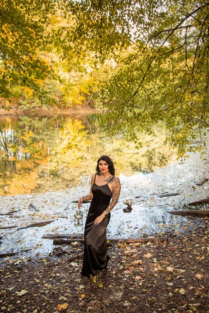 Portrait of chic darkhaired tattooed young woman