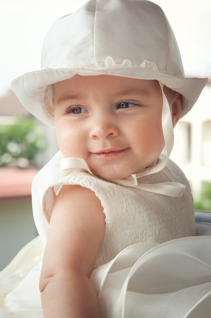 Portrait of a child a few months on the day of her baptism.