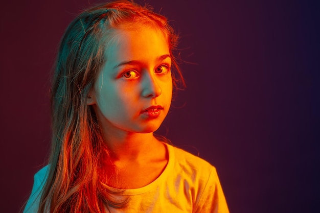 Portrait of a child girl Girl on a purple background with a color filter