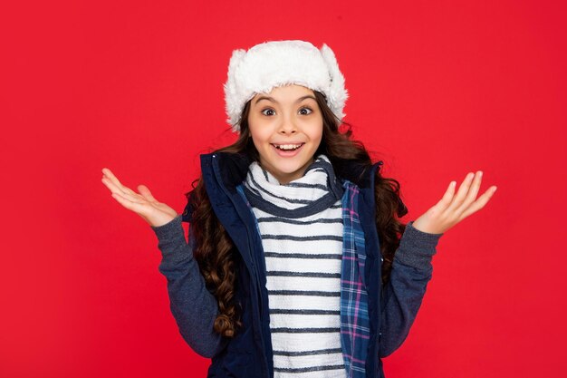 Portrait of child wearing warm clothes express positive emotion winter fashion amazed kid